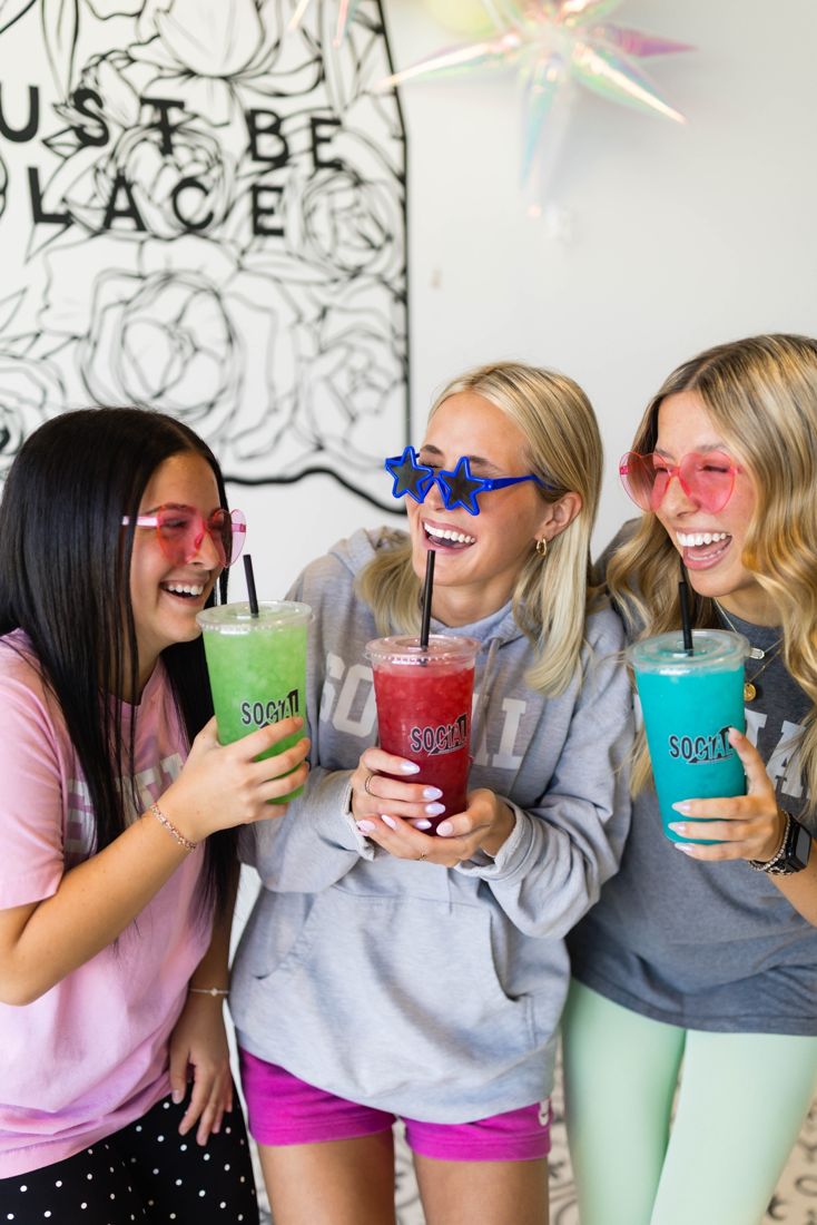 Three friends laughing with Social drinks